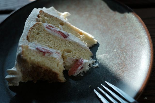 A slice of strawberry cake on a plate